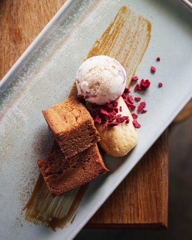 A favourite from our dessert menu - warm blondie with heavenly caramelised white chocolate mousse, salted caramel sauce, frozen raspberry, and white chocolate & raspberry ice cream.